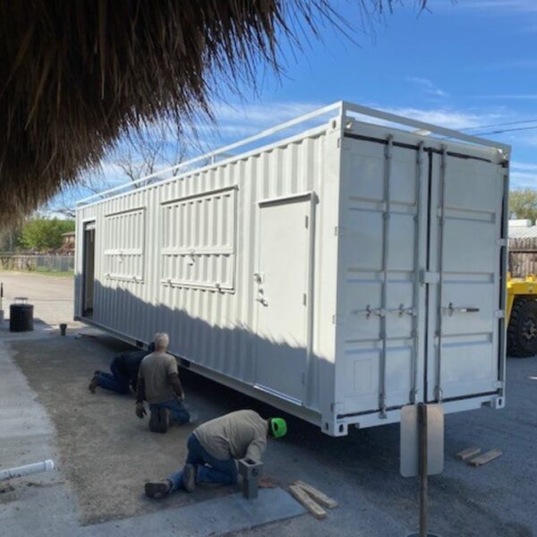 workers working on a shipping container