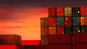 Stacked containers with a sunset in the background