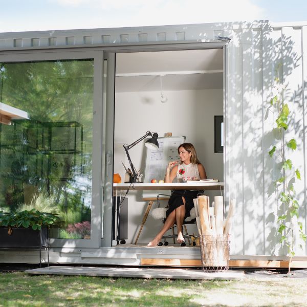 a lady sitting inside shipping container office