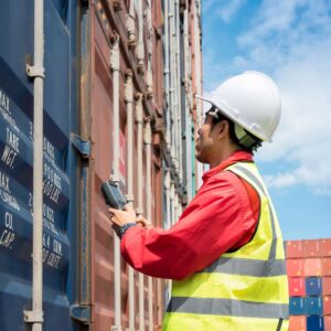 man inspecting shipping container