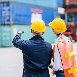 two people looking at shipping containers