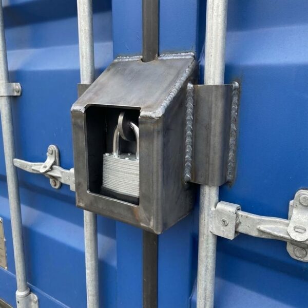 A steel lockbox welded onto the cargo doors of a blue shipping container